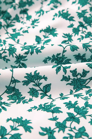 Shirred cami maxi dress fabric with a white background and teal floral print.