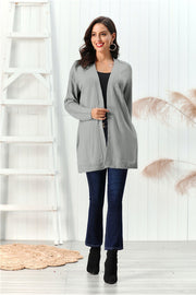 Gray cable knit open front cardigan with textured sleeves and open pockets.
