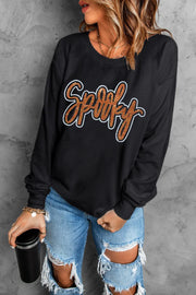 Black crewneck sweatshirt with orange glitter Spooky graphic.