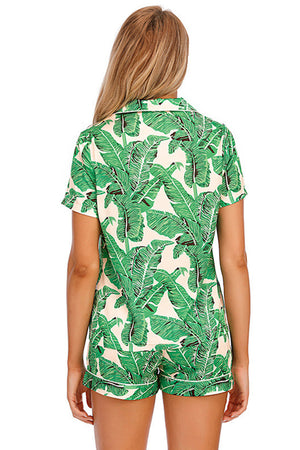 Green botanical print satin pajama set with buttoned top and shorts.