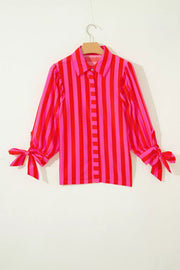 Vibrant puff sleeve stripe shirt with tie cuffs in pink and red cotton blend.