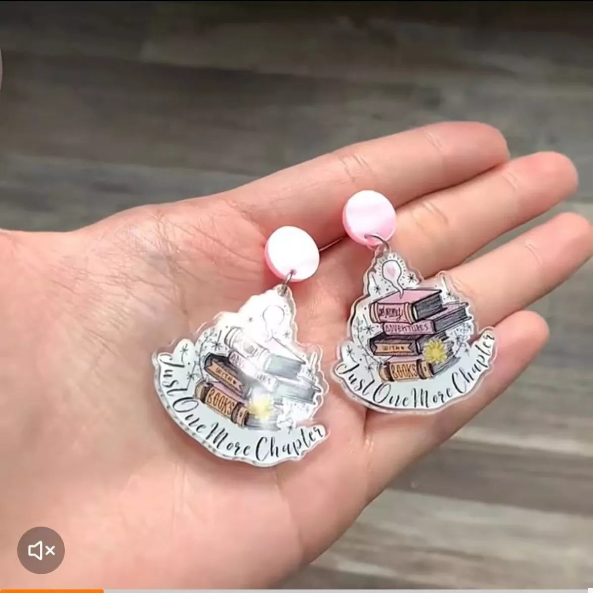 Book stack acrylic drop earrings in blush pink with "Just One More Chapter" text.