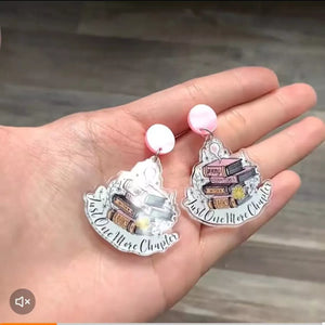 Book stack acrylic drop earrings in blush pink with "Just One More Chapter" text.