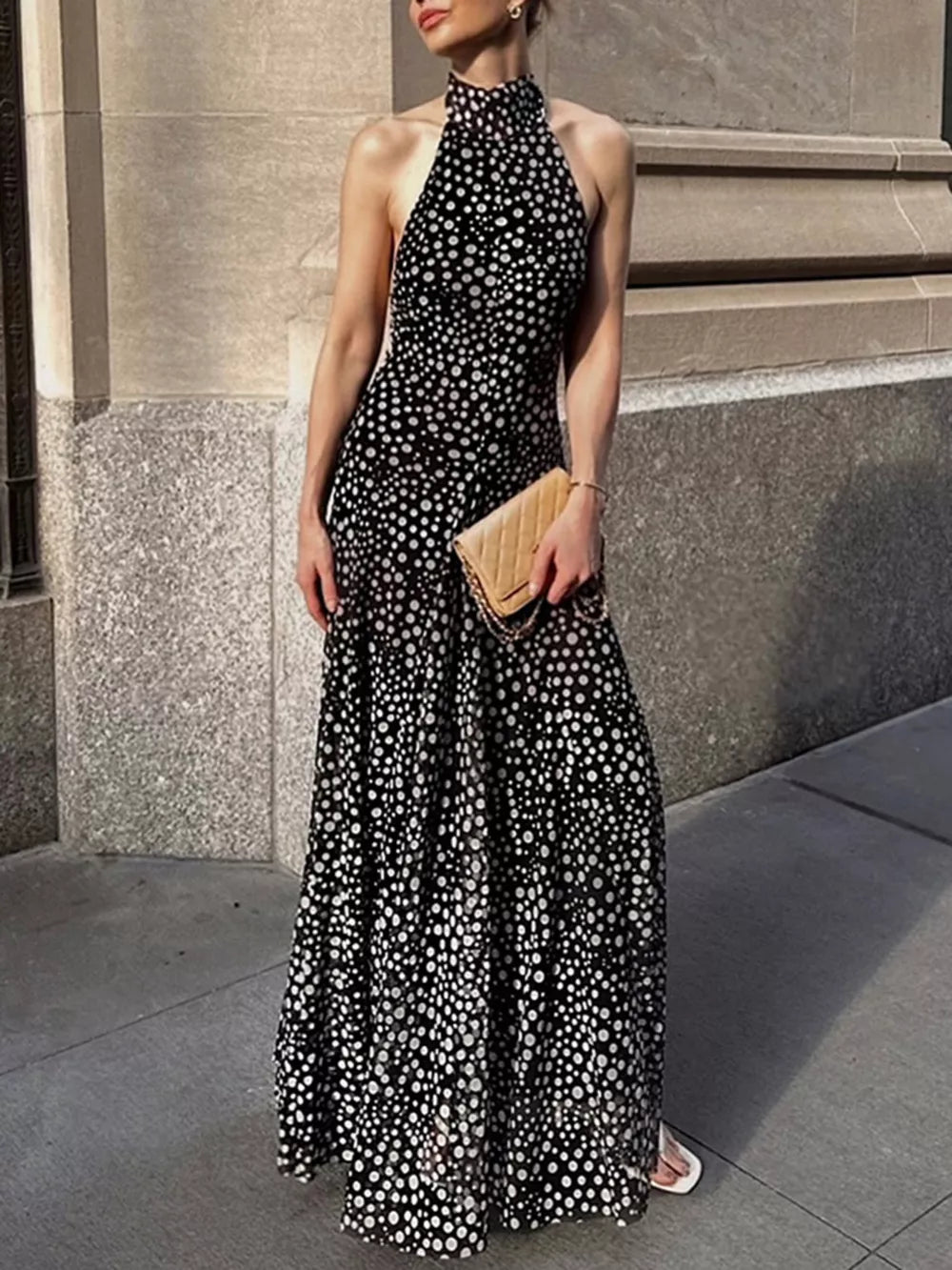 Chic polka dot halter maxi dress with a flowing skirt.
