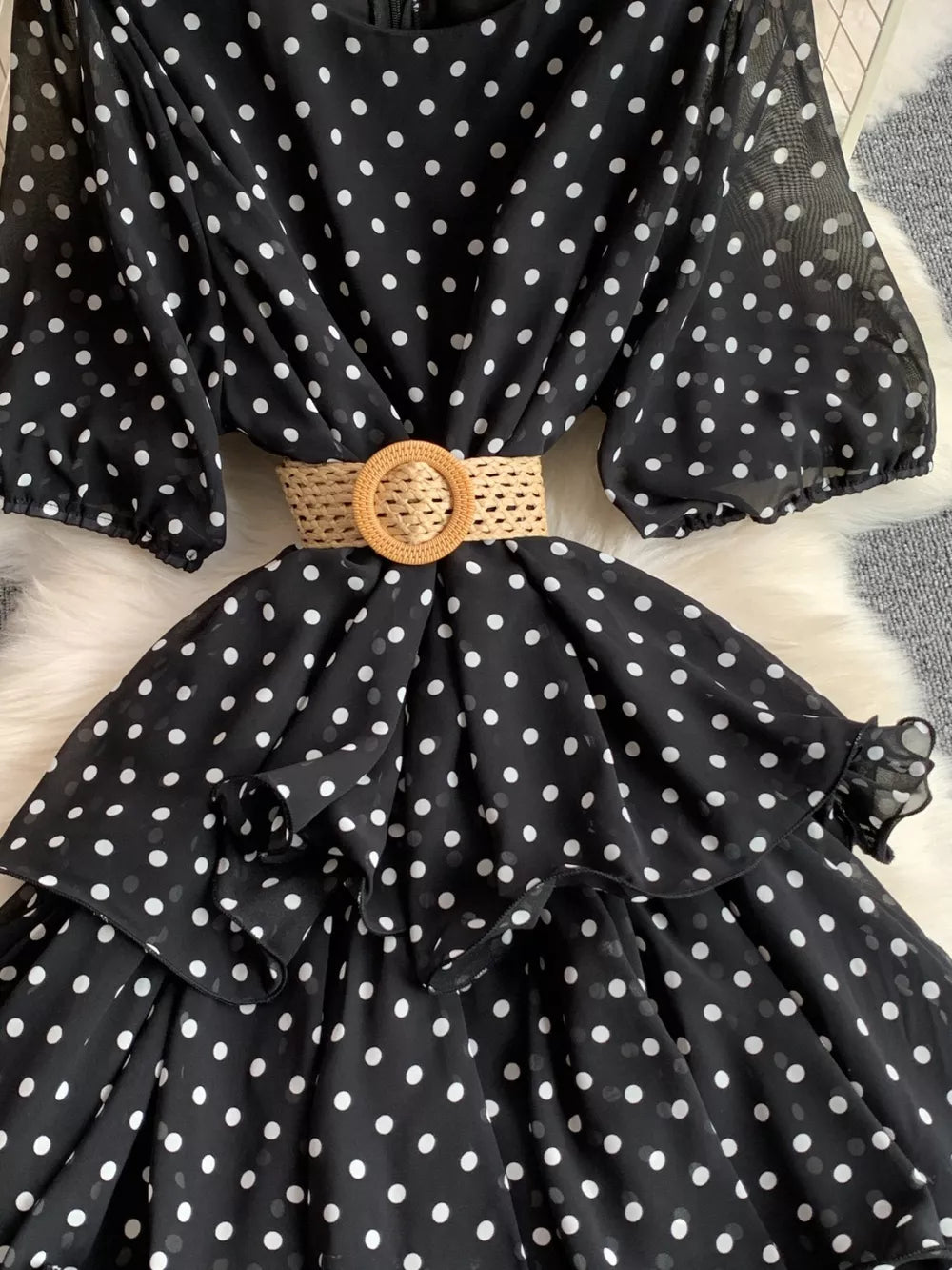 Black polka dot tiered midi dress with puff sleeves and woven belt