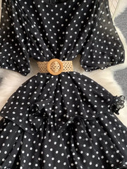 Black polka dot tiered midi dress with puff sleeves and woven belt