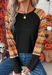 Black raglan tee with Aztec print sleeves in orange and cream, crew neck, long sleeves.