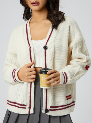 White cable knit cardigan with burgundy stripes and star detail.