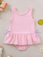 Pink striped seersucker one-piece swimsuit with ruffled hem and side bows.