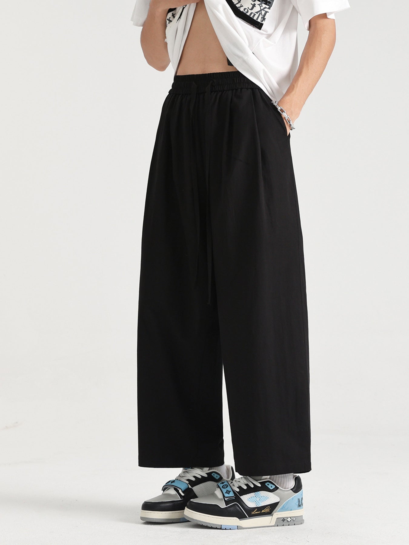Men's black lightweight drawstring sweatpants with a wide leg