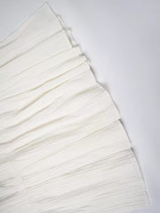White tiered maxi skirt with elastic waistband and textured fabric detail