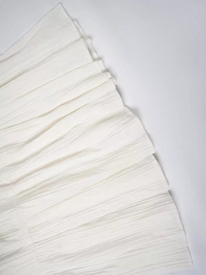 White tiered maxi skirt with elastic waistband and textured fabric detail