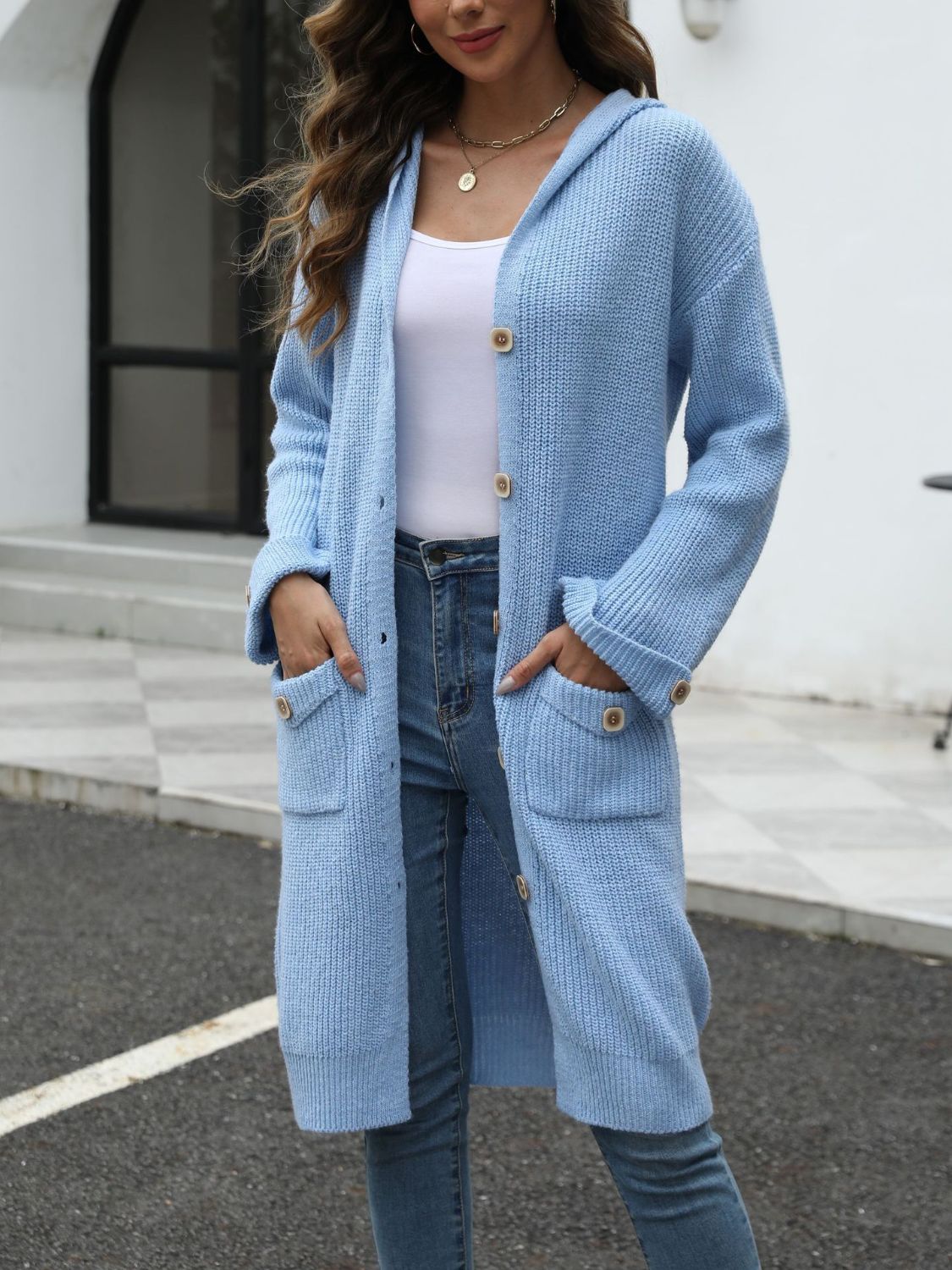 Light blue longline knit cardigan with hood, button front, and patch pockets.