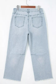 Light wash denim cropped utility jeans with frayed hem and knee detail