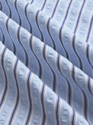 Maternity pants with blue and white vertical stripes and textured fabric detail.