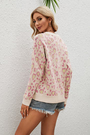 Light yellow acrylic sweater with pink and green heart print, drop shoulder, and crew neck.