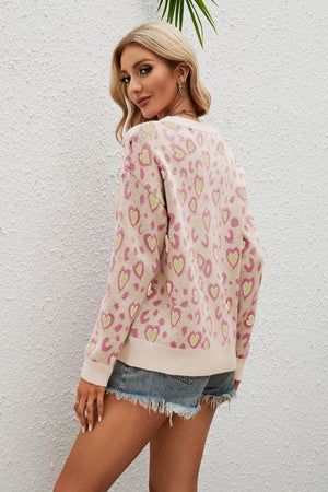 Light yellow acrylic sweater with pink and green heart print, drop shoulder, and crew neck.