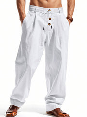 Men's white loose fit drawstring pants with button detail and pleats.