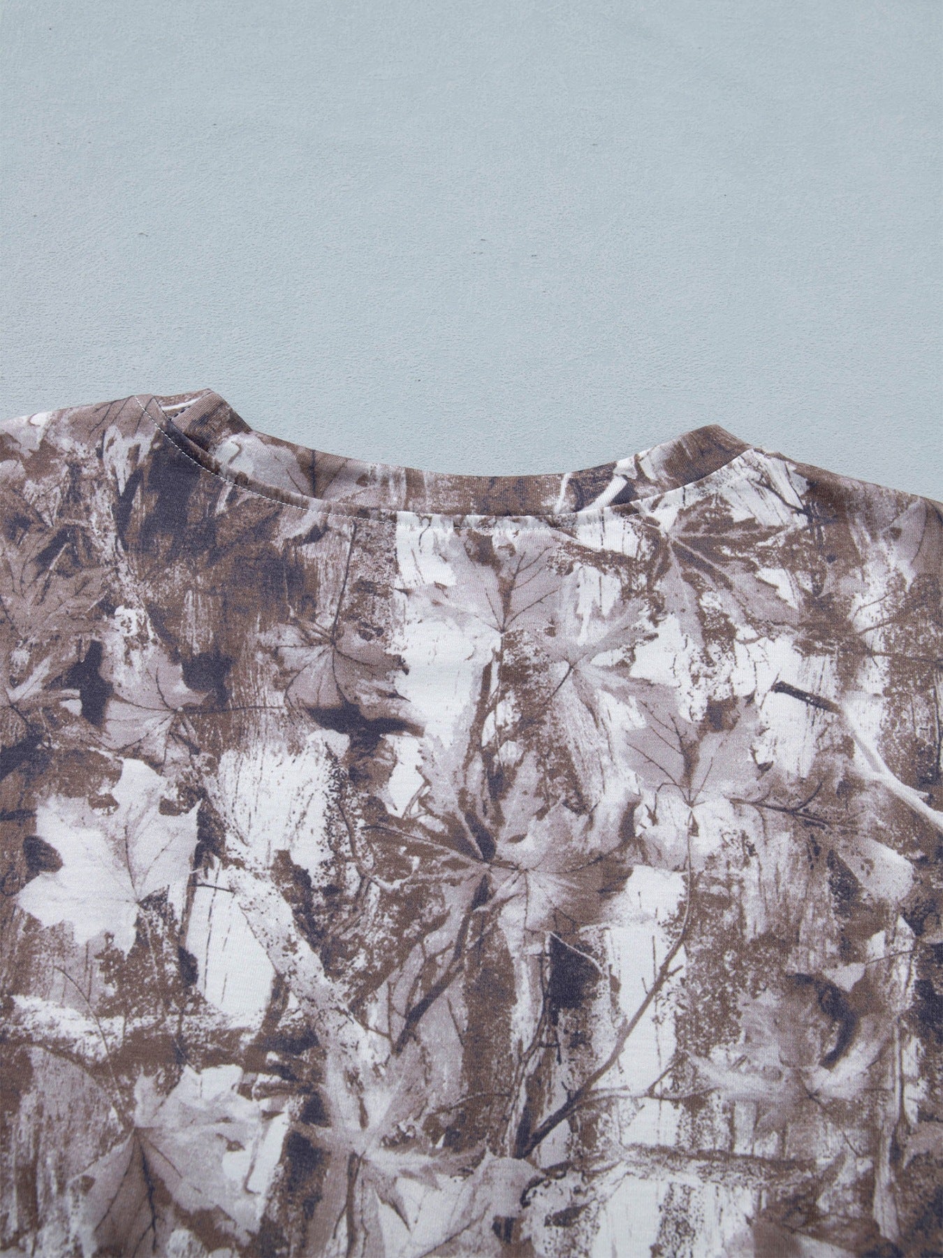 Woodland camouflage tunic with crew neck and drop shoulders.