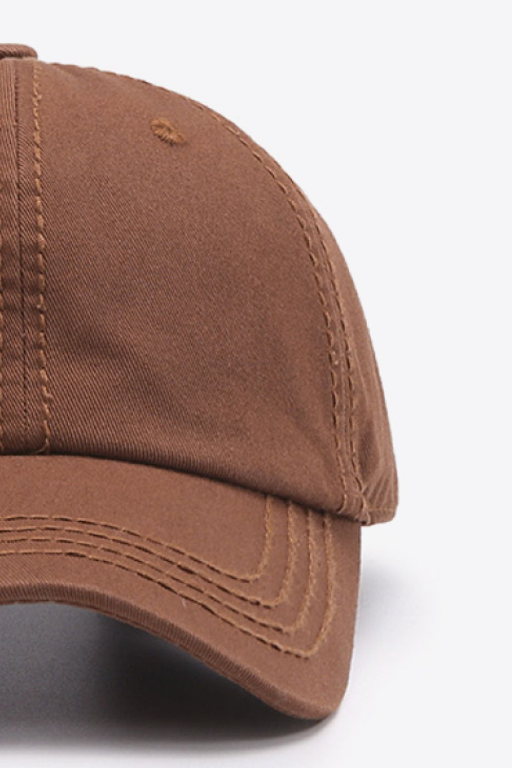 Brown canvas baseball cap with stitched details and eyelets.