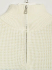 Cream ribbed knit sweater with half-zip neckline and textured waffle knit detail.