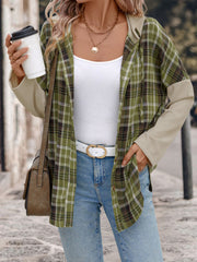 Colorblock plaid hooded shirt jacket in matcha green with contrasting sleeves and a button front.