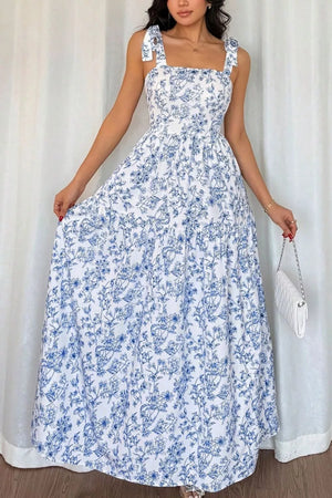 Maxi dress with blue floral print, square neck, tie straps, and tiered skirt.