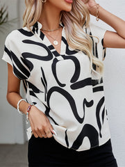 White abstract brushstroke V-neck blouse with short sleeves.