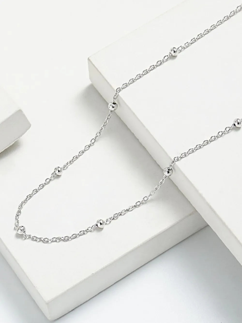 Delicate silver orb chain necklace with small, evenly spaced beads.