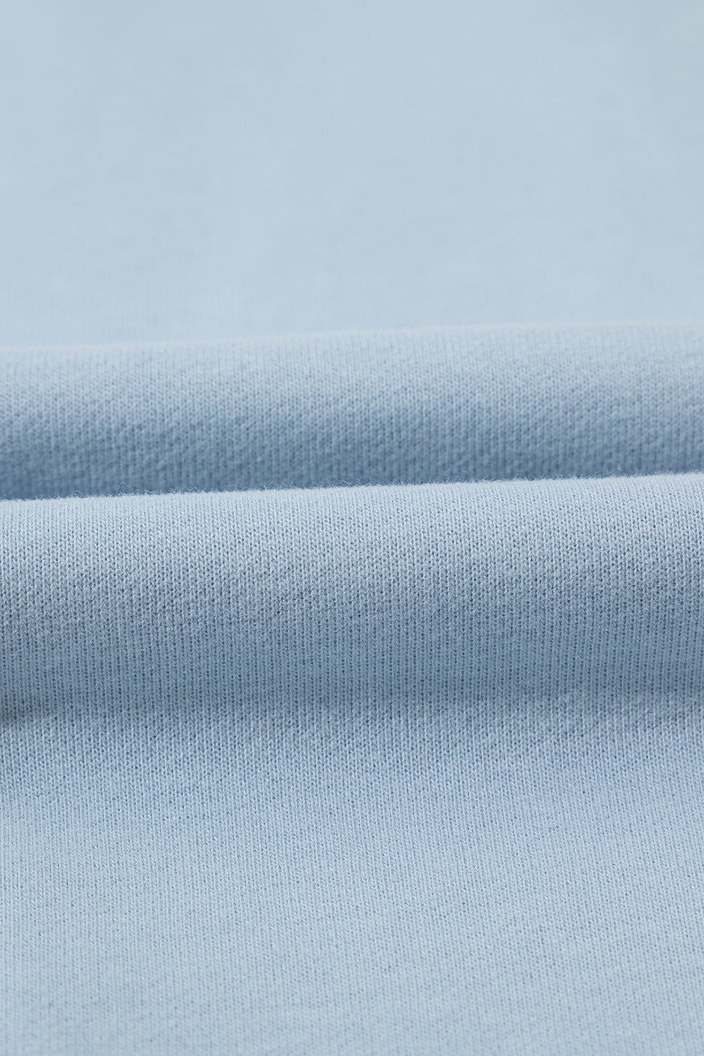 Light blue quarter-zip sweatshirt fabric detail