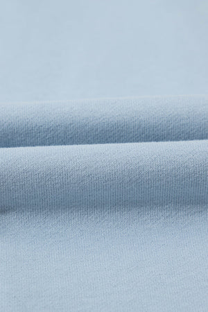 Light blue quarter-zip sweatshirt fabric detail