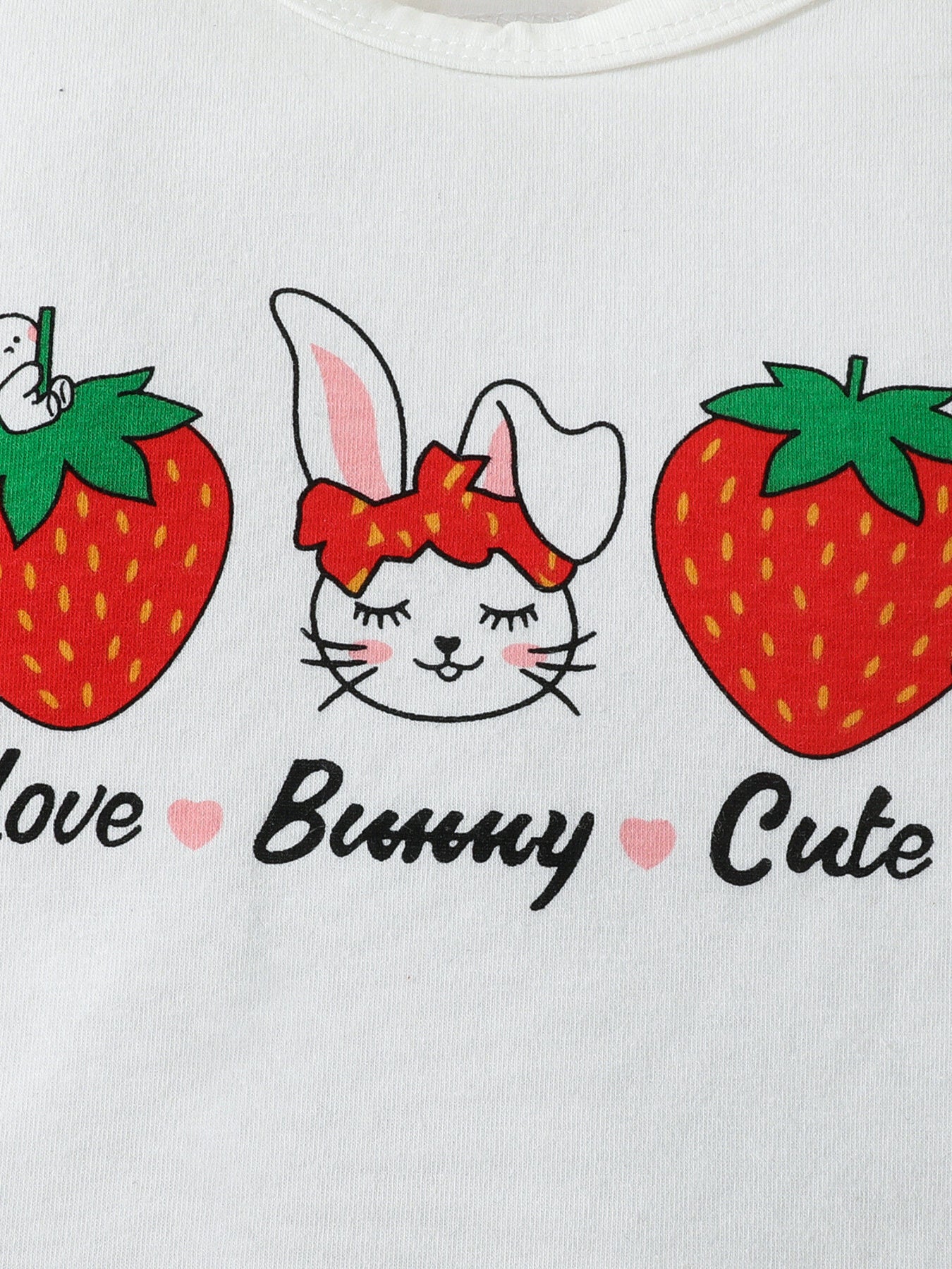 White baby bodysuit with bunny, strawberry, and text print