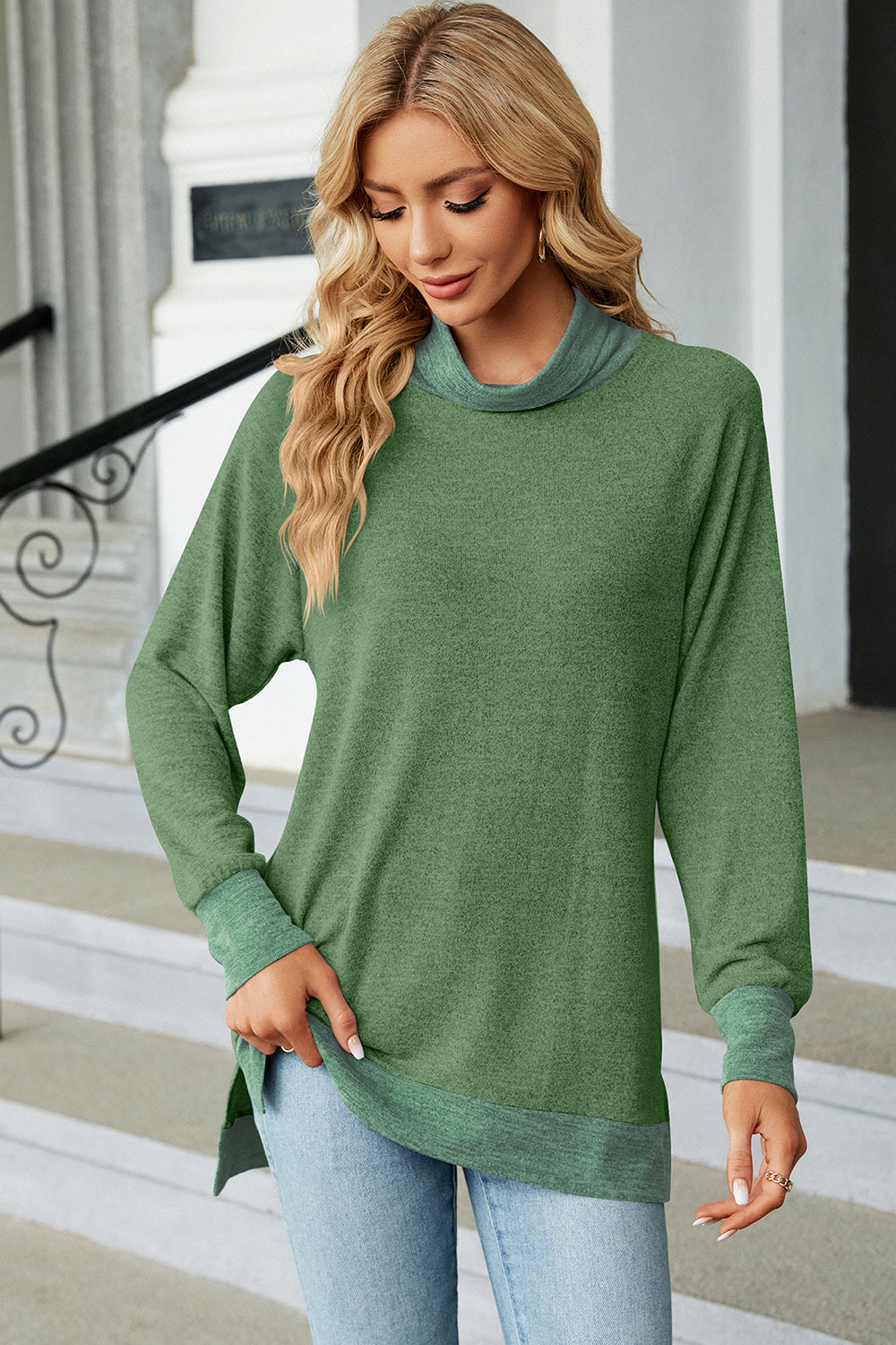 Colorblock raglan turtleneck tunic in green with contrasting trim and cuffs.