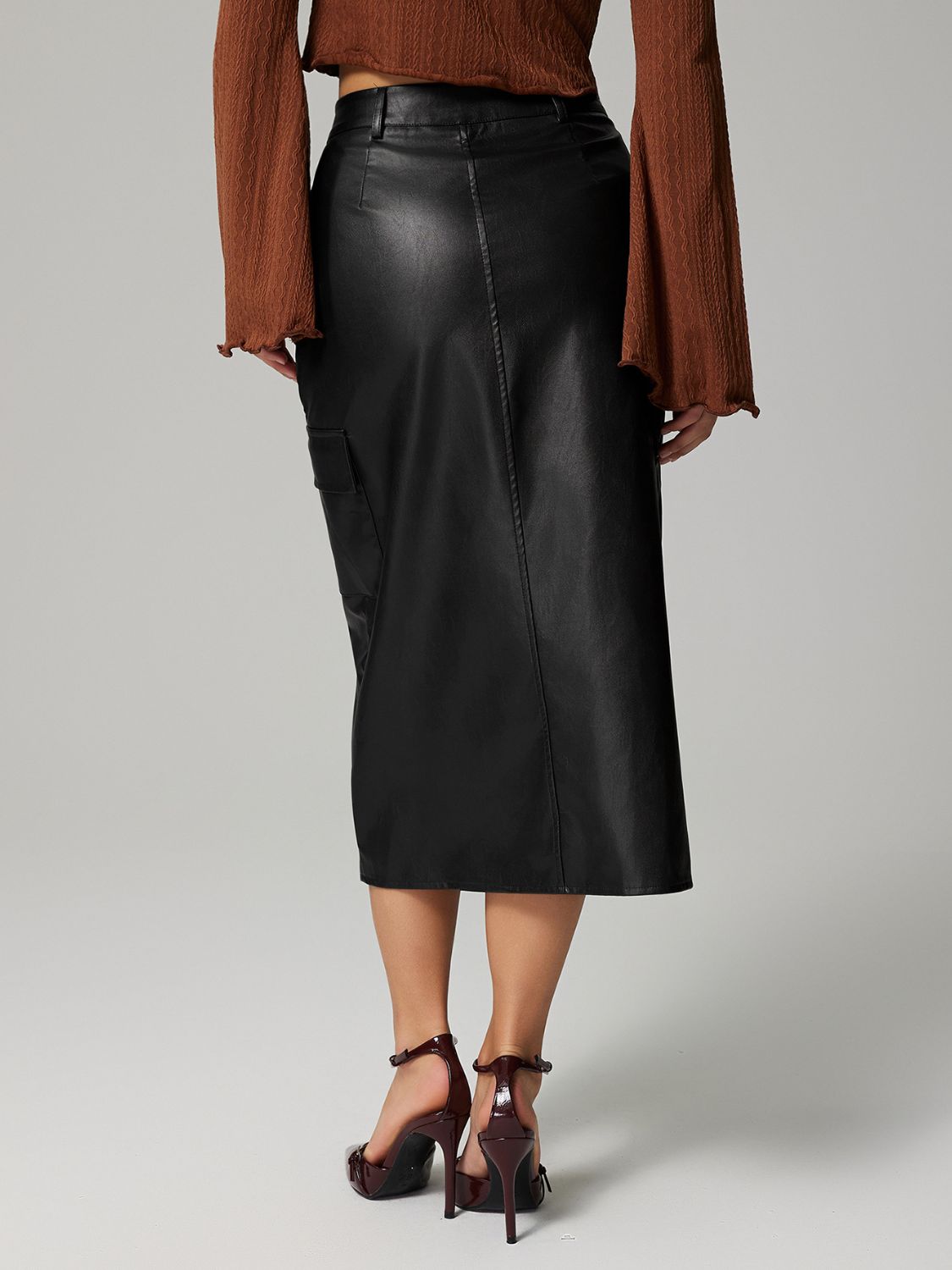 Black faux leather midi skirt with utility pocket detail.