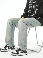 Classic loose fit vintage denim jeans in light wash cotton, styled with sneakers.