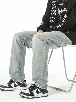 Classic loose fit vintage denim jeans in light wash cotton, styled with sneakers.