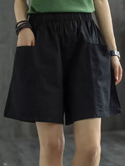 Black chino shorts with elastic waist and large front pockets.