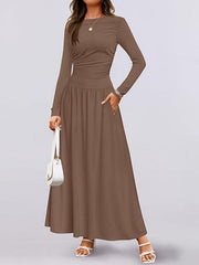 Elegant ruched maxi dress with pockets in coffee, long sleeves, cinched waist, and flowing skirt.