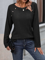 Black ribbed knit raglan sweater with button trim on the shoulder and neckline.