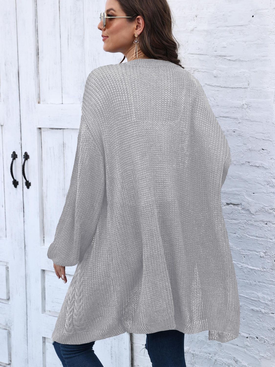 Light gray acrylic cable knit cocoon cardigan with relaxed fit and long sleeves.