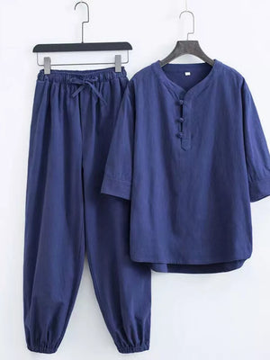 Navy blue Chinese-inspired men's relaxed fit pants set with drawstring waist and button-up V-neck top.
