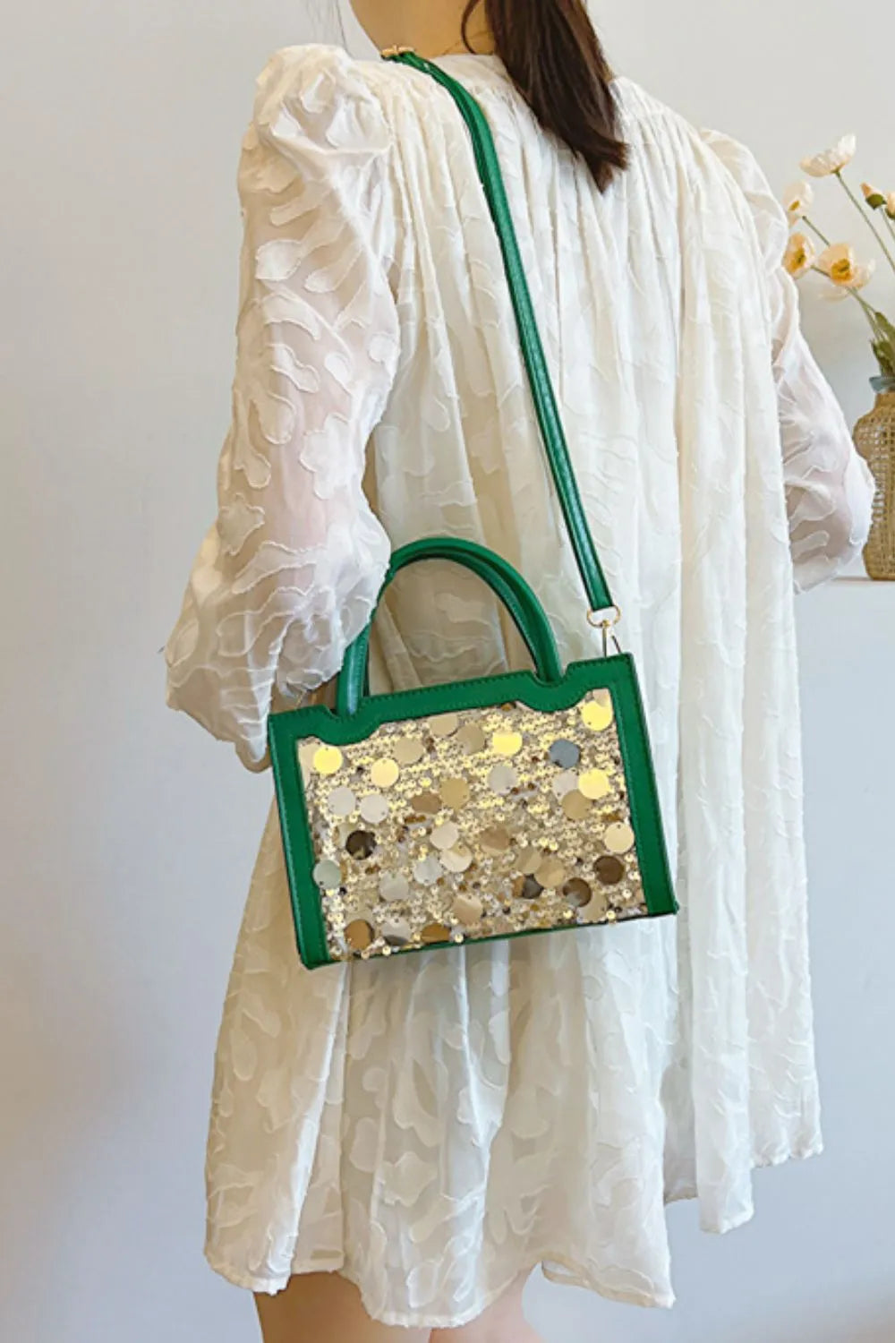Green sequin embellished structured mini bag with gold sequins and top handles.