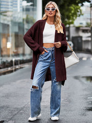 Open-stitch waffle knit duster cardigan in deep red, open front, long sleeves.