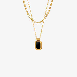 Gold double-layered necklace with figaro and curb chains, featuring an onyx inset rectangular pendant.