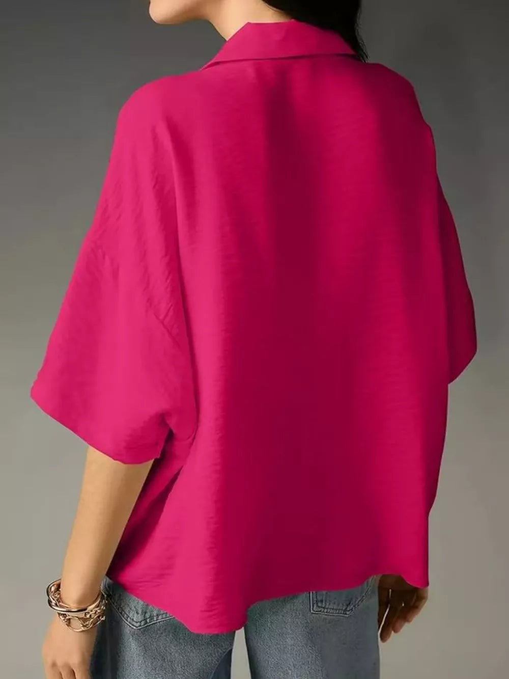 Hot pink half sleeve shirt with a collared neckline and relaxed fit.