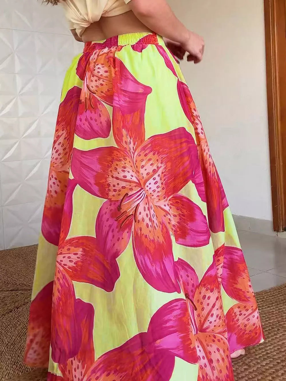 Vibrant floral maxi skirt with pockets in bright pink and orange lily print on lime green.