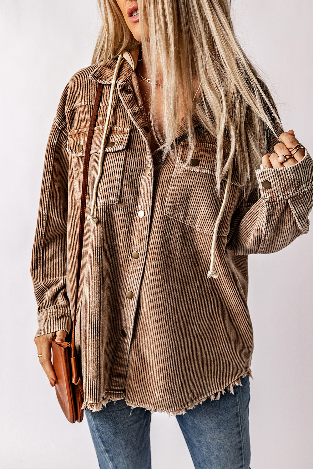 Tan corduroy hooded utility jacket with frayed hem and chest pockets.