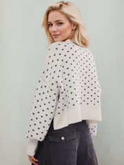 Dotted knit cropped crewneck sweater in white with dark blue pattern, crewneck, long sleeves, and ribbed hem.