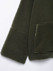 Olive green sherpa jacket with a textured fleece fabric and a patch pocket detail.