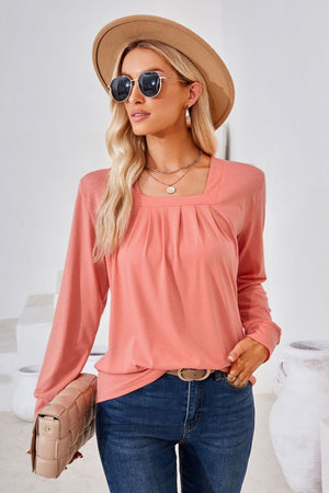 Burnt Coral jersey top with gathered square neckline and long sleeves.